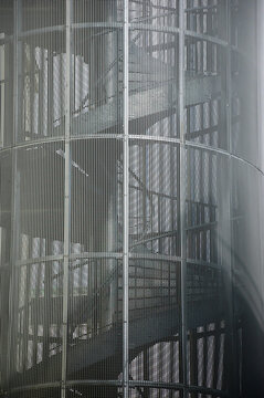 Fire escape spiral metal stairs on a building .Urban architecture background. 
