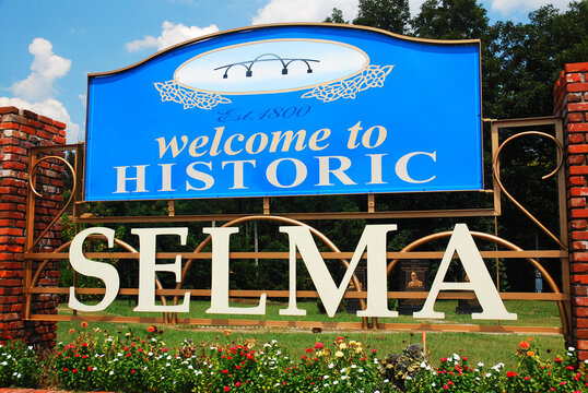 A sign at the side of the highway, at the town line welcomes people to historic Selma Alabama