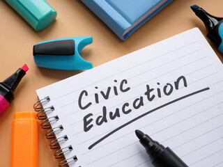 Open notebook with words civic education and marker.