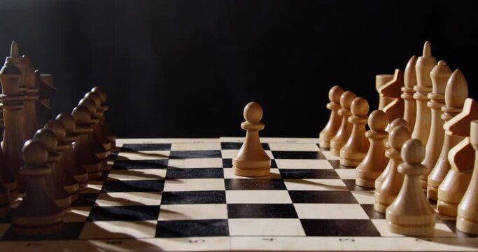 wooden chess pieces on a chessboard in smoke