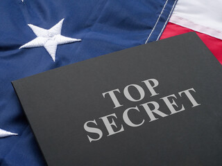 Fototapeta na wymiar US flag and a folder labeled Top Secret.