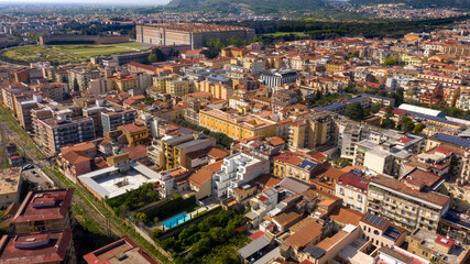 Fototapeta premium Aerial view of the historic center of Caserta, in Campania, Italy. In background the Royal Palace of Caserta also known as Reggia di Caserta, symbol of the city.