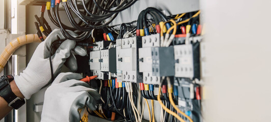 Electrician engineer tests electrical installations and wires on relay protection system. - obrazy, fototapety, plakaty