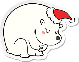 cute sticker cartoon of a polar bear wearing santa hat