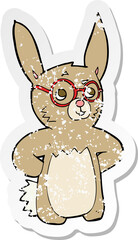retro distressed sticker of a cartoon rabbit wearing spectacles