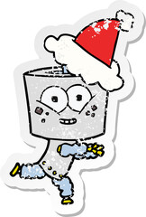 happy distressed sticker cartoon of a robot wearing santa hat