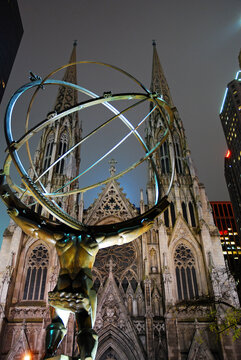 A sculpture of Atlas Stands Strong, lifting the world in Front of St Patrick's Cathedral, New York