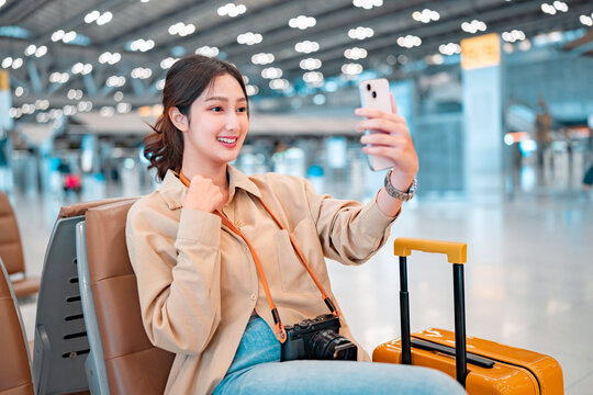Happiness asian woman take selfie photo in airport terminal, female using smartphone take photo, Tourist journey trip concept.
