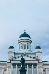 Fototapeta na wymiar Minimalist look of lutheran finish cathedral over cloudy sky with green domes