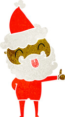 man with beard sticking out tongue wearing santa hat