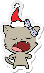 sticker cartoon of a yawning cat wearing santa hat