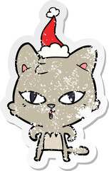 distressed sticker cartoon of a cat wearing santa hat