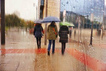 people with an umbrella in rainy days in winter season, bilbao, basque country, spain