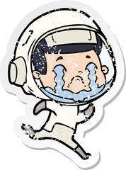 distressed sticker of a cartoon crying astronaut