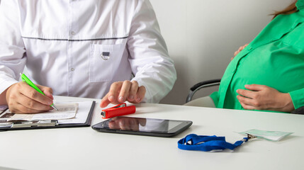 The obstetrician-gynecologist writes out the direction of a pregnant girl for an abortion. Risks of...