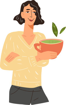 Woman drinks tea in a cup. Happy woman with cup of hot green or matcha tea.