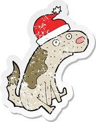 retro distressed sticker of a cartoon dog in christmas hat