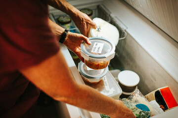 Putting away food in the freezer