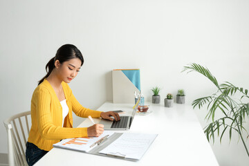 Happy millennial woman using the computer at Home