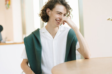Teenager is Laughing at Table