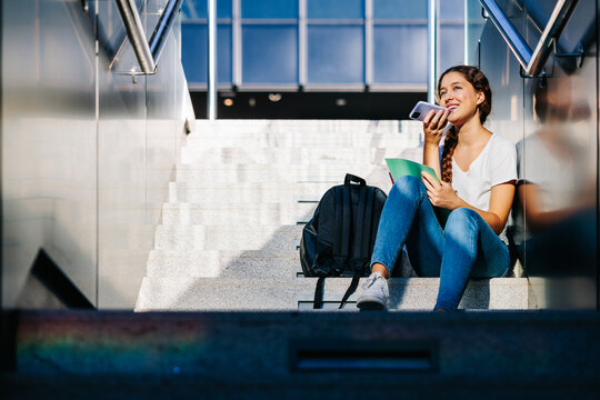 Friendly blonde college student sending an audio message to her friend