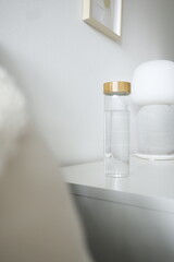 Reusable glass bottle on a white surface. - 593665880