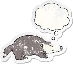 cartoon badger and thought bubble as a distressed worn sticker