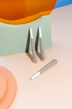 Cannabis prerolls with colorful objects