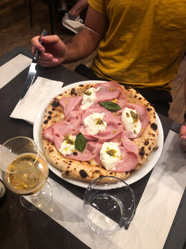 UGC mortadella pizza on restaurant table 