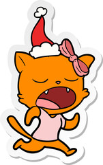 Obraz na płótnie Canvas sticker cartoon of a yawning cat wearing santa hat