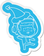 cartoon  sticker of a tired astronaut wearing santa hat