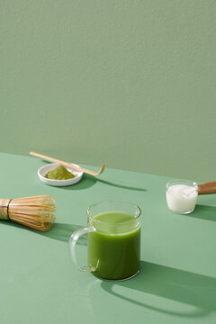 tea glass with matcha latte - ice, matcha green tea, milk