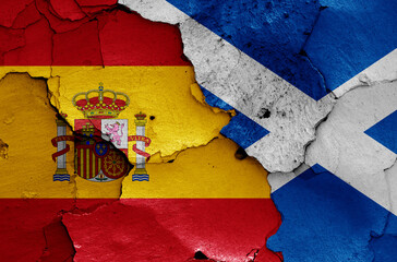 flags of Spain and Scotland painted on cracked wall