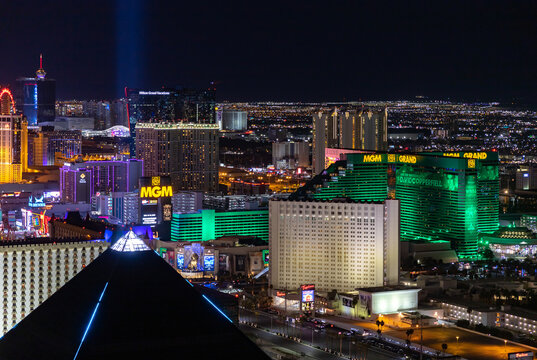 Las Vegas, United States - November 24, 2022: A picture of Las Vegas at night, showing the MGM Grand, the Tropicana Las Vegas, and the top of the pyramid of the Luxor Hotel and Casino.