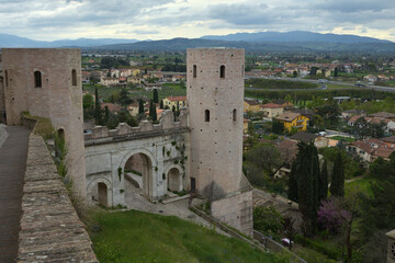Fototapeta na wymiar View of Spello medieval village and roman Porta Venere or Venus Gate. Perugia, Umbria, Italy, Europe
