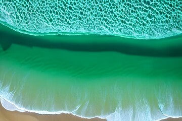 green Ocean waves on the beach as a background. Beautiful natural summer vacation holidays background. Aerial top down view of beach and sea with blue water waves