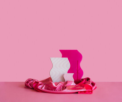 Set of curved plastic abstract objects on pink coral background