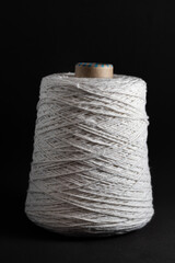 roll of string on a black background