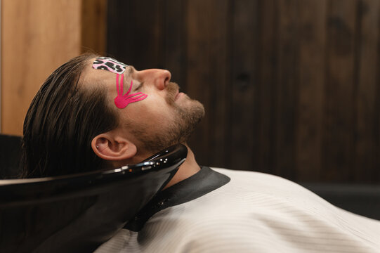 Male client putting head in sink