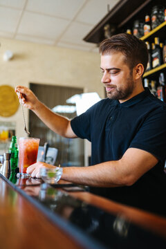 Bearded man working in pub in daytime
