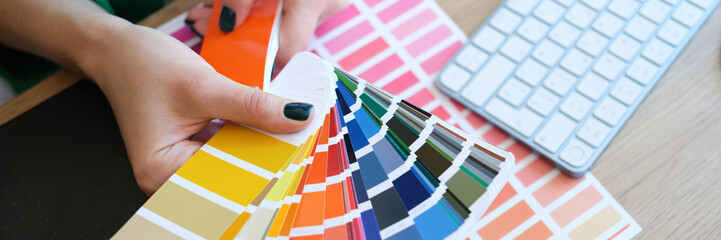 Interior designer holding fan of multicolored samples