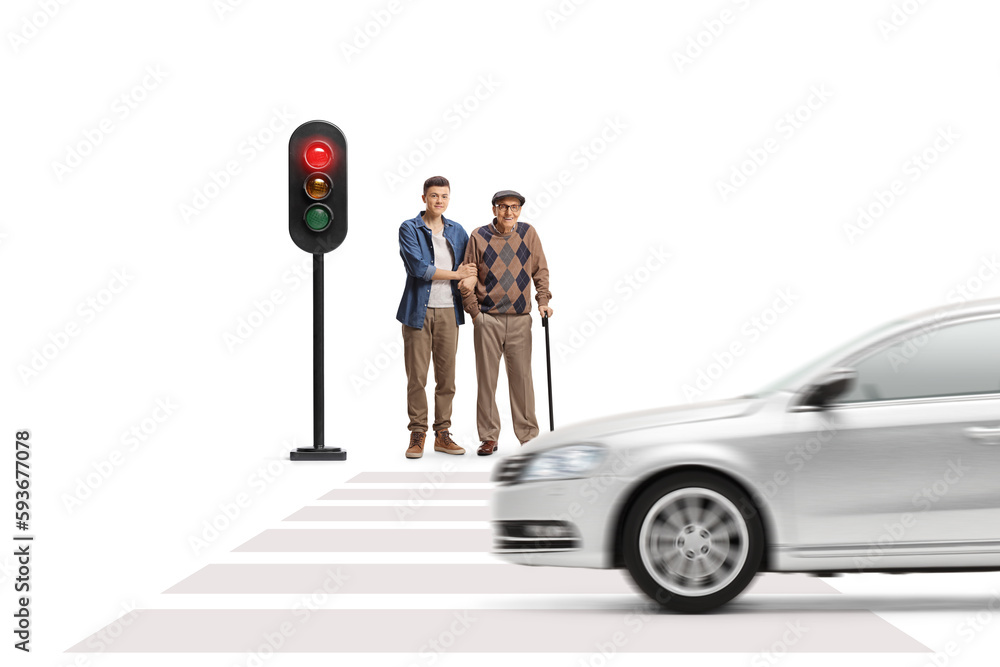 Canvas Prints Full length portrait of a guy helping an elderly man walking with a cane and waiting at a traffic light