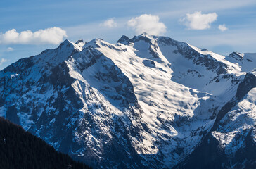 Obraz premium Cloudy blue morning sky over the French Alps mountains, Alpe d'Huez, France