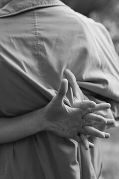 man's hands behind his back