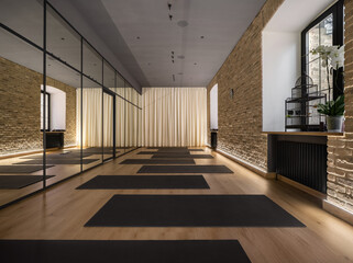 Modern interior of yoga studio with mirrored wall