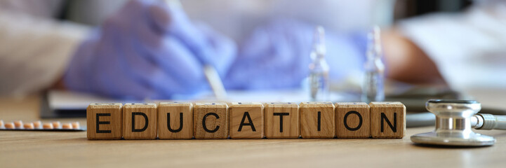 Word education collected of wooden cubes in raw