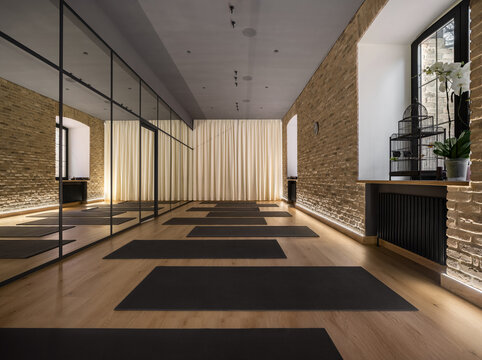 Modern interior of yoga studio with mirrored wall