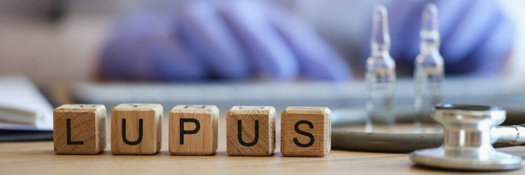 Word lupus collected of wooden cubes in raw