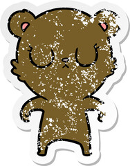 distressed sticker of a peaceful cartoon bear
