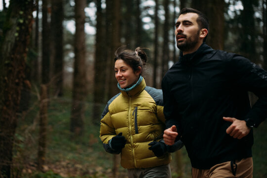 Man and Woman Running Outdoors 